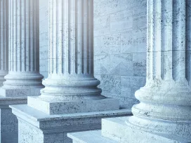 Government building with stone columns. Exponent provides scientific and engineering expertise for the government and public sectors.