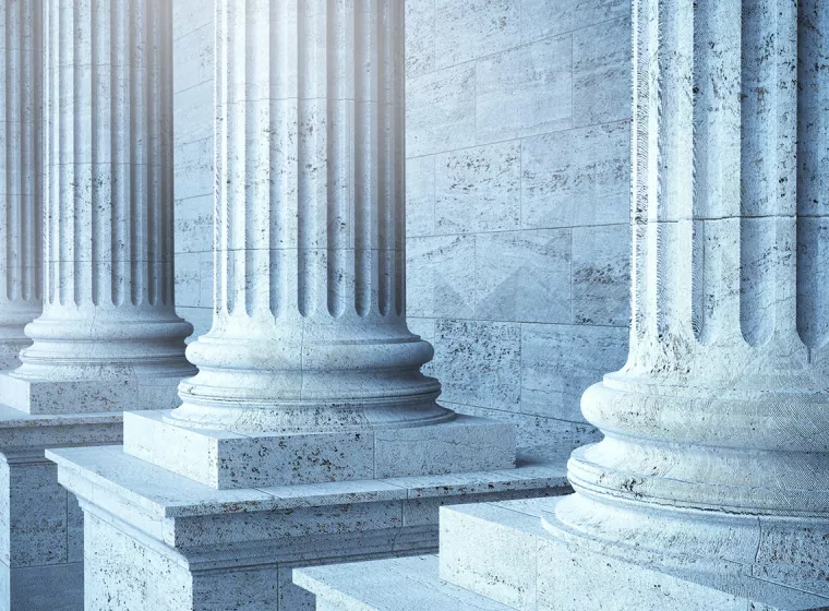 Government building with stone columns. Exponent provides scientific and engineering expertise for the government and public sectors.