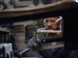 A worker examines mechanical components in Exponent's Natick research laboratory.