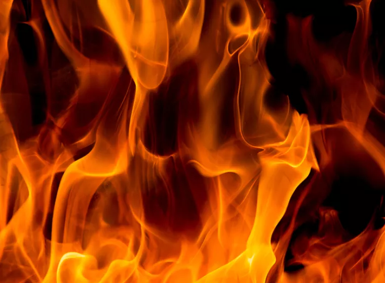 Bright flames on dark background. Exponent thermal scientists perform fire investigations and investigate explosions.