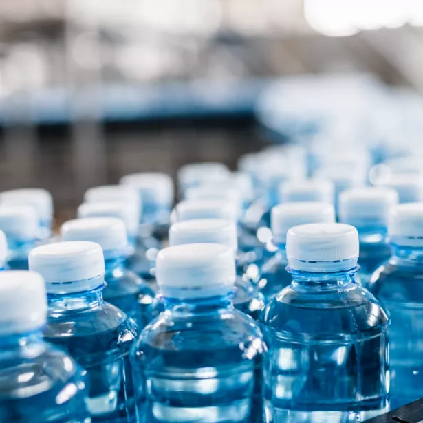 Water bottle packaging and assembly. Exponent consultants help with selection, testing, and analysis of food packaging 