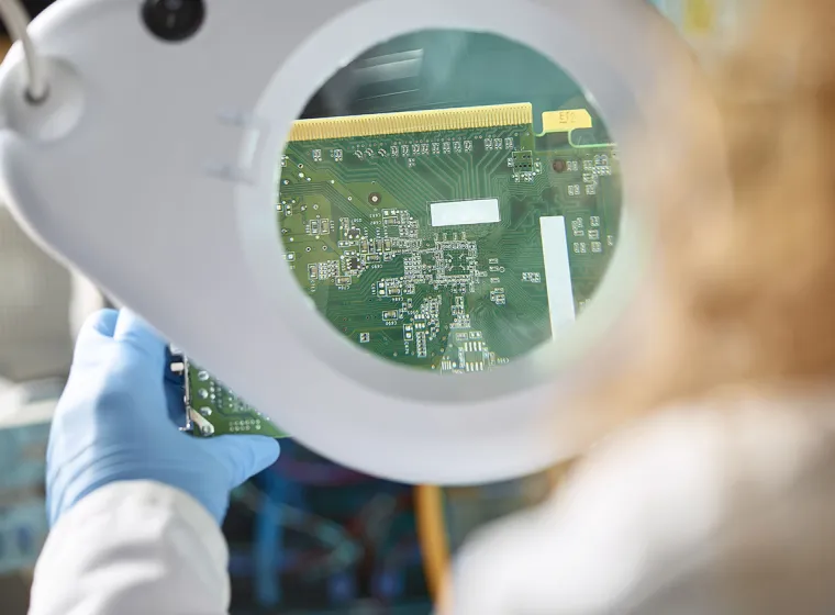 An Engineer evaluating electronic components. Exponent electrical engineers and computer scientists consult on  electronics.