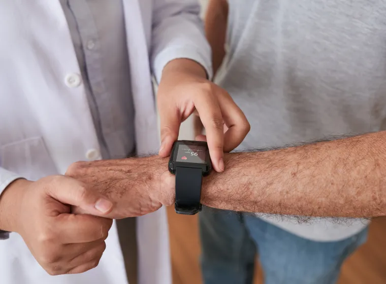 Doctor helping patient use a smart watch