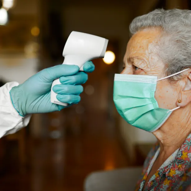Woman Having Temperature Taken