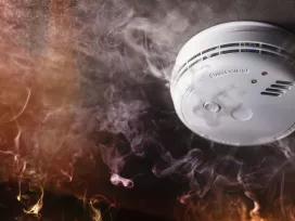 Fire alarm surrounded by smoke. Exponent performs fire and flammability testing of consumer products.