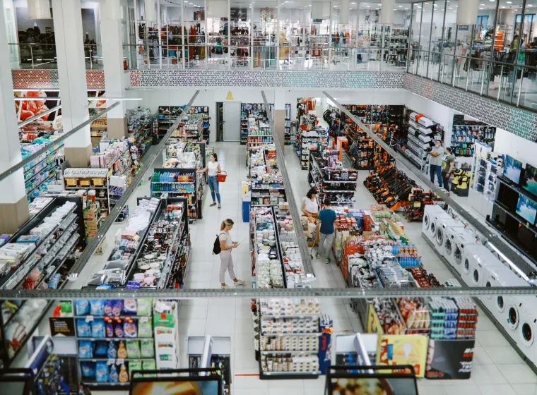 Overhead image of people buying in the large supermarket.