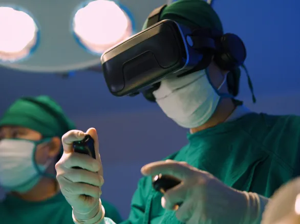 Professional surgeons in uniform and VR headset performing operation on patient in modern clinic.