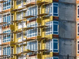 construction work at height during facade insulation from scaffolding or staging, selective focus