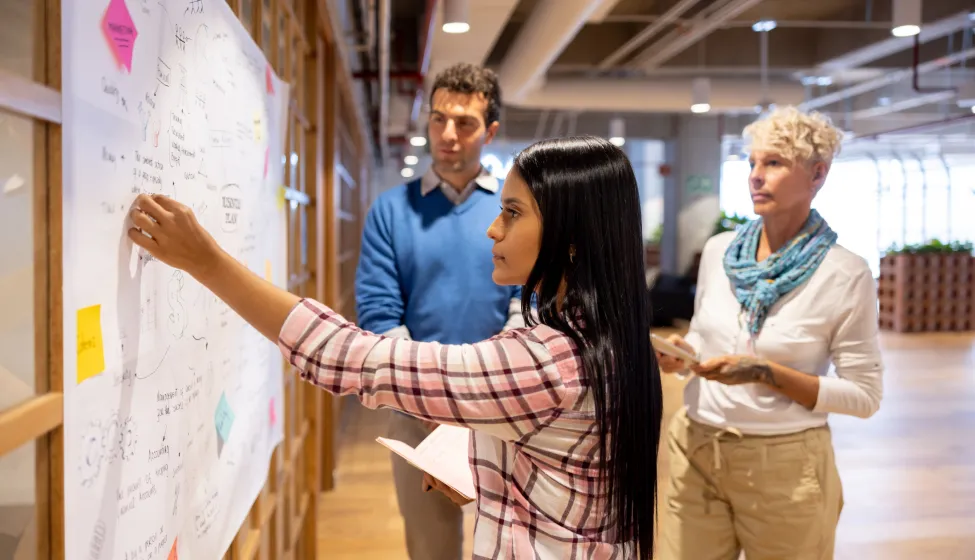 Latin American business team brainstorming at the office while creating a business strategy