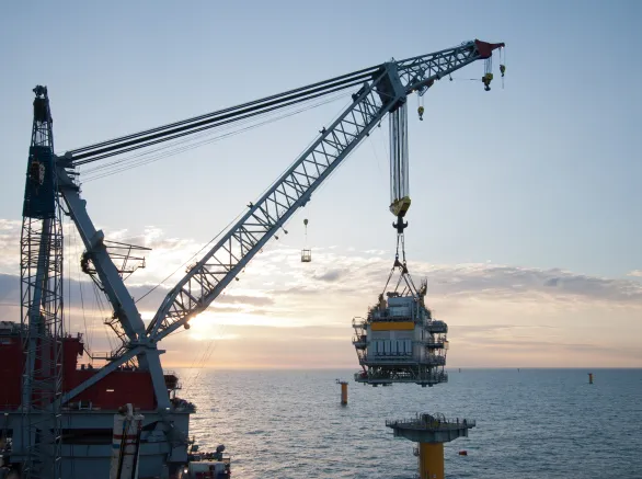 crane vessel installing a transformer platform in a windfarm