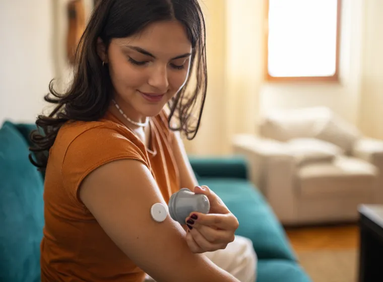 diabetic patient using glucose sensor on arm