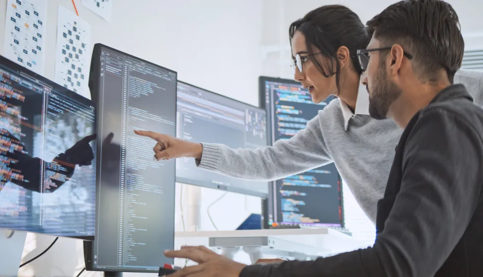 Hispanic Latin American couple, software engineer developer use computer, work on program coding together at home office. Programming language development technology, freelance job concept