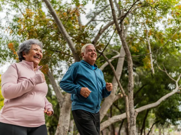 Senior couple talking and running on public park