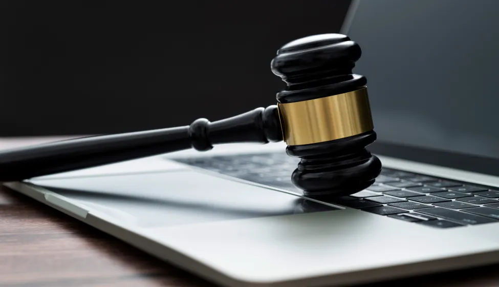 Gavel and laptop on the table