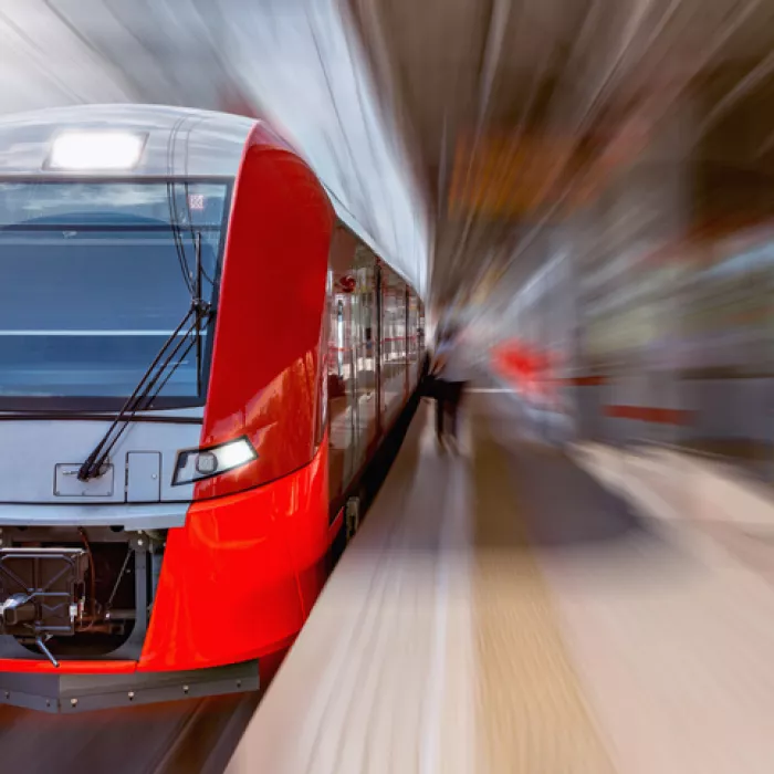 High speed passenger train in station. Exponent helps improve the safety and performance of rail transportation.