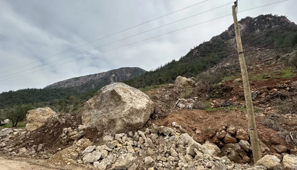 Crumbling stone and telephone pole on the side of the road following the Turkey earthquake