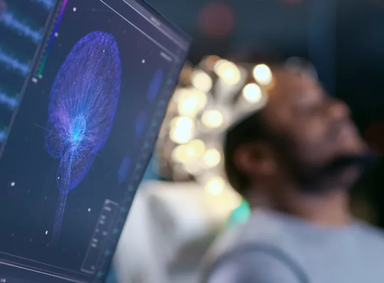 Monitor showing EEG reading of human brain for biomechanical product evaluation and product safety testing