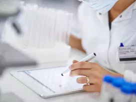 Medical lab coat and employee badge. Exponent assists with pharmaceutical research for medical innovators.