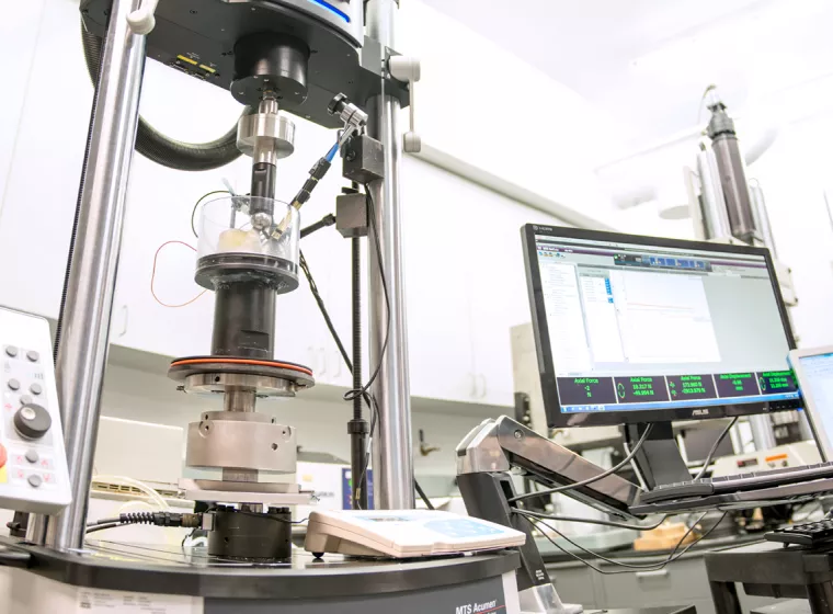 Scientific laboratory with testing machines and computers. Exponent's biomedical engineering laboratory.