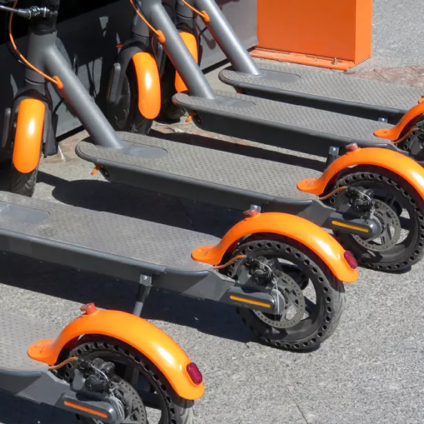 A line of e-scooters parked outside