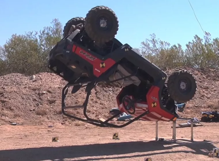 A Jeep suspended from a crane drops in a product evaluation test performed by Exponent vehicle engineers. 