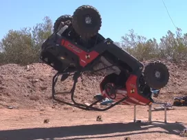 A Jeep suspended from a crane drops in a product evaluation test performed by Exponent vehicle engineers. 