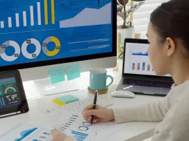 Woman working on spreadsheets at computer